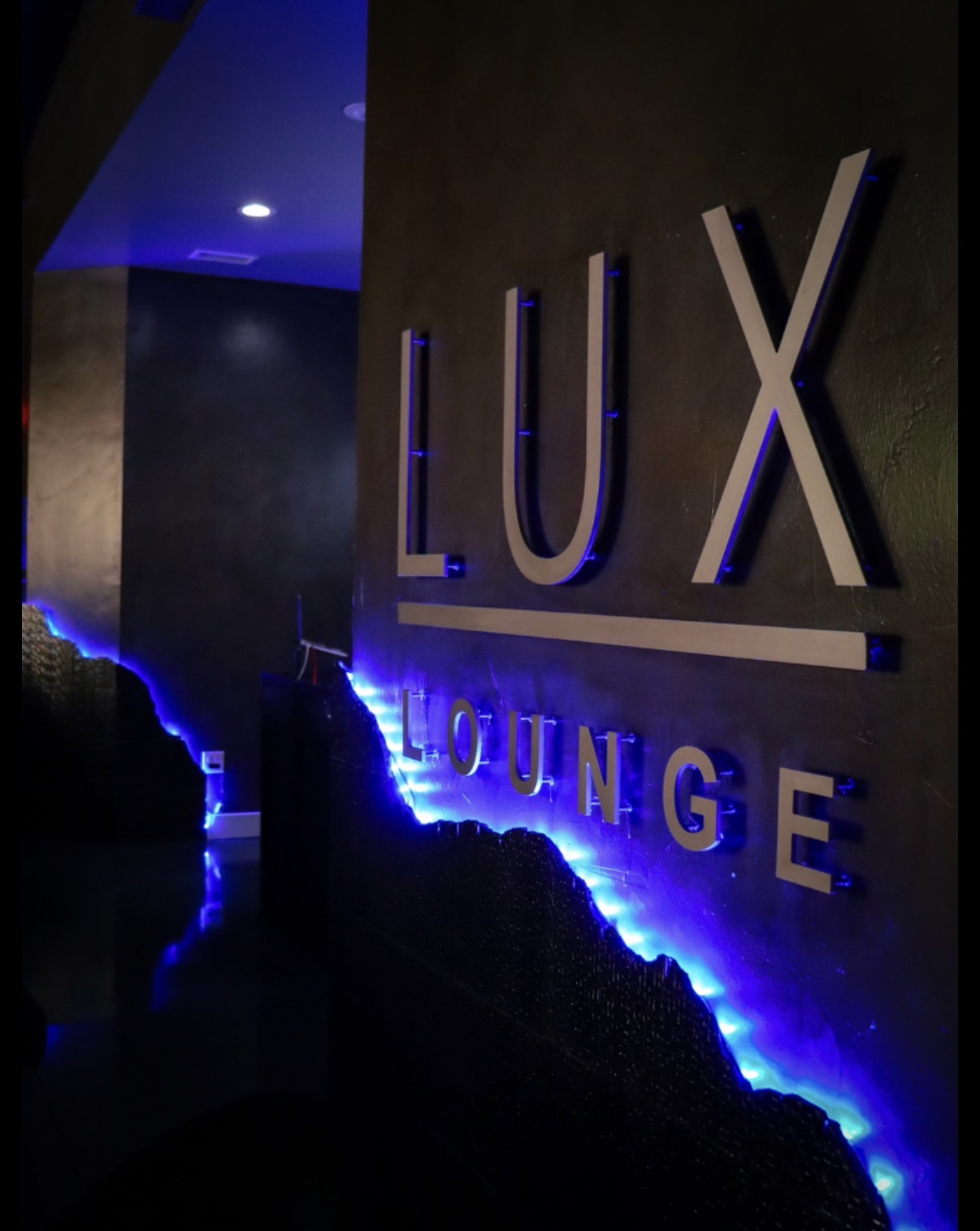 Lux Lounge entrance signage with blue LED lighting